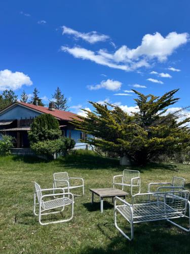 a group of chairs and a table in the grass at Chalet Ricciano in Foligno