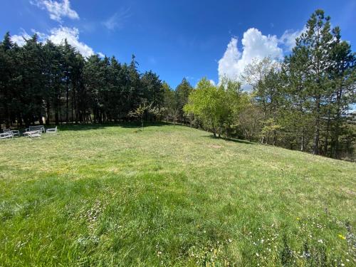a large grassy field with two chairs on top of it at Chalet Ricciano in Foligno