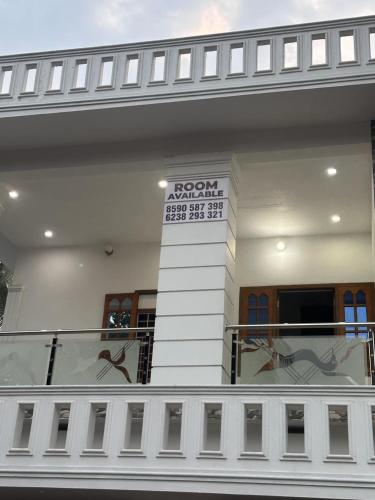 a balcony of a building with a sign on it at Whitehouse Homestay-Iqra Hospital Calicut in Kozhikode