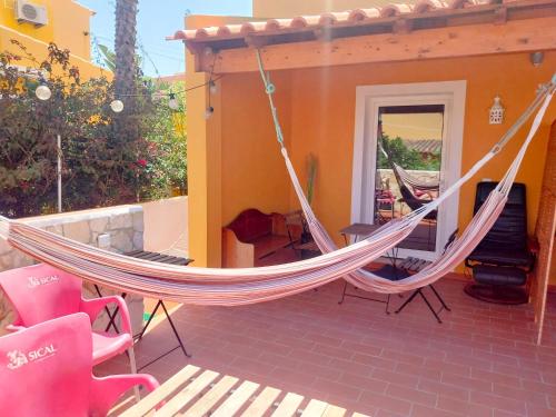 a hammock on a patio with a house at SolemCabana Social Club in Lagos