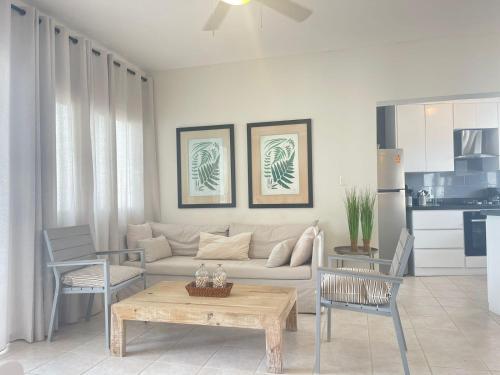 a living room with a couch and a table at Stanza Mare Beach Front in Punta Cana