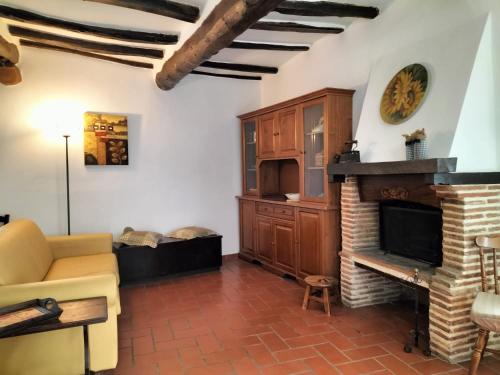 a living room with a couch and a fireplace at La Piazzetta - Locazione turistica nel centro storico di Acquasparta in Acquasparta
