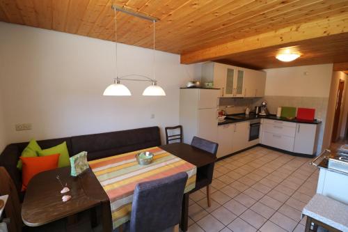 a living room and kitchen with a table and a dining room at Fewo Turmblick in Oberried