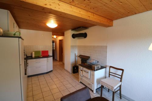 a kitchen with a table and a chair in a room at Fewo Turmblick in Oberried