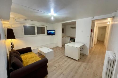a living room with a couch and a table at Appartement en soubassement in Port-de-Bouc