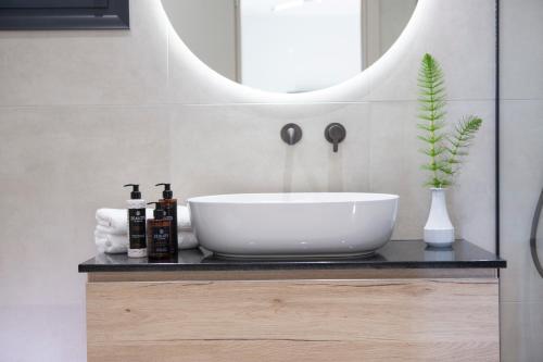 a bathroom with a sink and a mirror at Pomaria Boutique Residences in Lefkada Town
