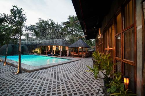 a swimming pool in front of a building at Marika Resort in Badian