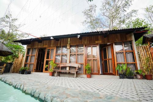 a house with a bench in front of it at Marika Resort in Badian
