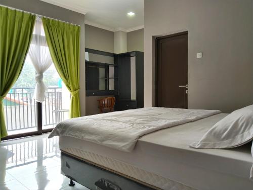 Ένα ή περισσότερα κρεβάτια σε δωμάτιο στο Roemah Tebet