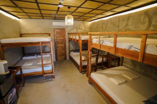 a room with four bunk beds in it at Marika Resort in Badian