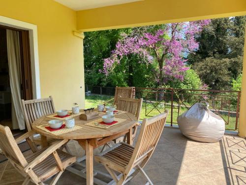 a wooden table and chairs on a patio at KARMA House by the River in Paramythia