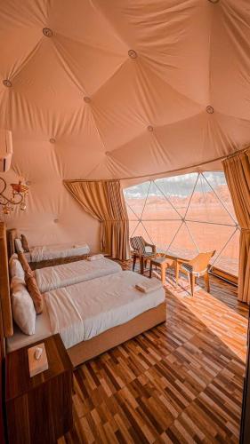 a bedroom with a large bed in a tent at Wadi rum Gory camp in Disah