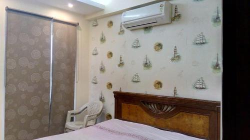 a bedroom with a bed and a shower and a window at Luxury Flat in Faridabad