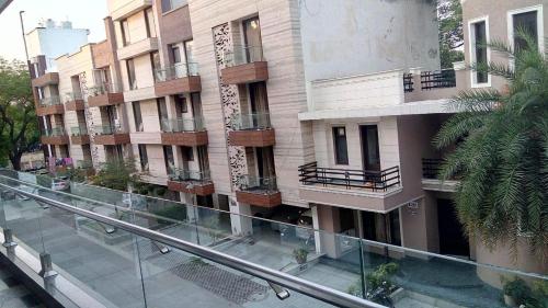 an apartment building with balconies and a street at Luxury Flat in Faridabad