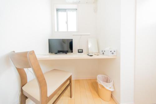 a white desk with a chair and a television at Tokyo Private House 大塚の宿 in Tokyo
