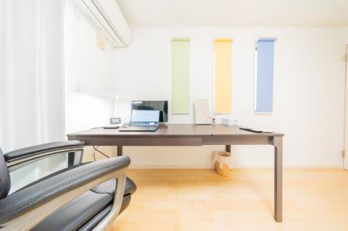 an office with a desk with a laptop on it at Tokyo Private House 大塚の宿 in Tokyo