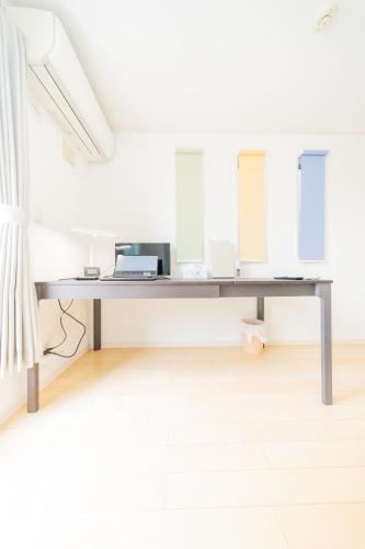 a desk in a white room with two mirrors at Tokyo Private House 大塚の宿 in Tokyo