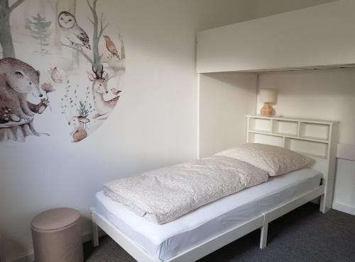 een witte slaapkamer met een bed en een muur bij Unterkunft - Alte Hofstraße - in Damlos