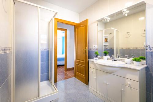 a bathroom with a sink and a shower and a mirror at Rodenas Valero Alborea in Alborea