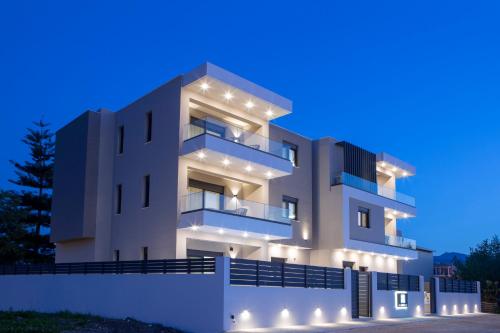 a building with lights on it at night at Pomaria Boutique Residences in Lefkada Town