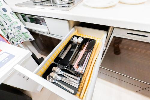 a drawer in a kitchen with utensils in it at Tokyo Private House 大塚の宿 in Tokyo