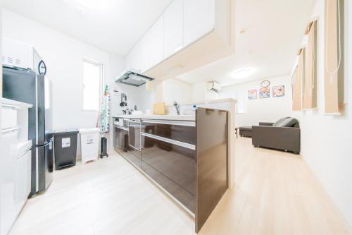 a kitchen with a stainless steel refrigerator at Tokyo Private House 大塚の宿 in Tokyo