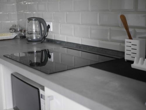 a kitchen counter with a tea kettle on it at Prestige Apartments in Rivne