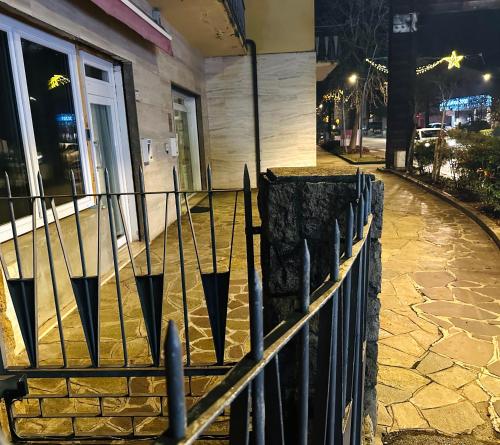 a fence in front of a building at night at Mini Alloggi Alle Terme in Abano Terme