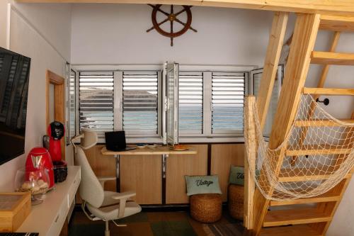 a room with a hammock and a desk and a window at Las Velas in Las Palmas de Gran Canaria