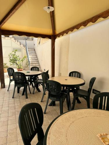 a group of tables and chairs in a room at Savoia in San Vito lo Capo