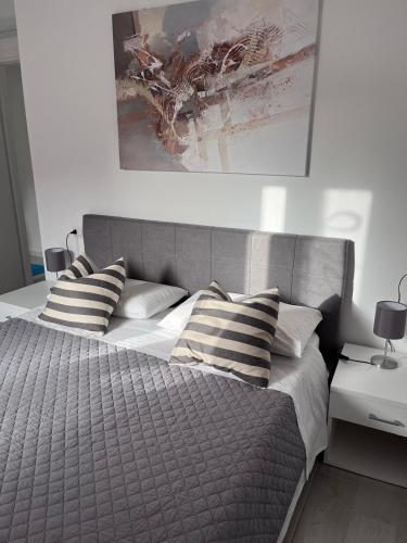 a bedroom with a large bed with striped pillows at CASA PATTY in Castelsardo