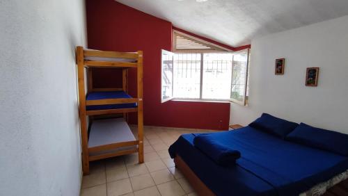 a bedroom with a bunk bed and a ladder at Maré Alta Hostel in Ubatuba