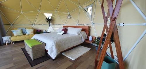 1 dormitorio en una tienda de campaña con 1 cama y 1 sofá en Ararat Eco Farm, en Coto Brus