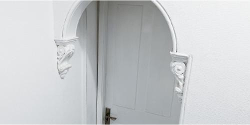 a white door with an arched window and a handle at Single Room in Modern House near Nottingham in Nottingham