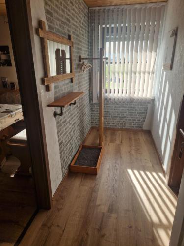 a hallway with a wooden floor and a brick wall at Landhaus Dreibirken in Rothenburg ob der Tauber