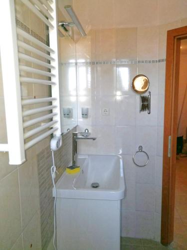 a white bathroom with a sink and a shower at Sapphire Mountain 2 in Bansko