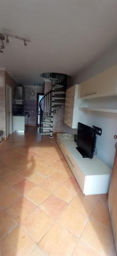 a living room with a couch and a staircase at Da Vinci House in Fiumicino