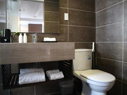 a bathroom with a toilet and a sink and a mirror at Ocean View Nha Trang in Nha Trang