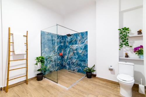 a glass shower in a bathroom with plants at Monastiraki Luxury Loft in Athens