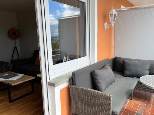 a living room with a couch and a window at Hotel Landhaus Sternen in Sipplingen