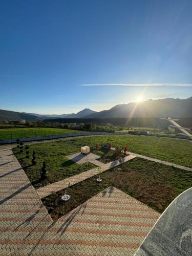 a view of a field with the sun shining at Villa Morina in Tropojë