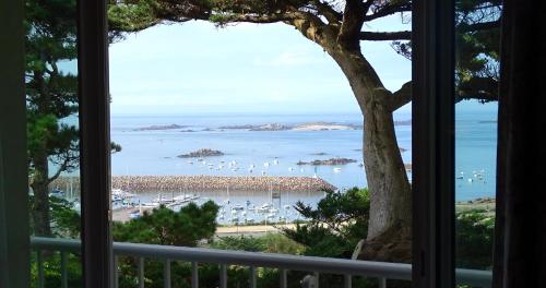 a view of a beach from a window at TI AL LANNEC Hotel - Restaurant & Spa in Trébeurden
