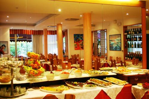 un restaurant avec de nombreuses assiettes de nourriture sur les tables dans l'établissement hotel bengasi, à Rimini