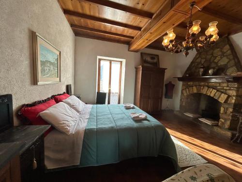 a bedroom with a bed in a room with a fireplace at appartamento storico Valle San Martino di Spoleto in Spoleto