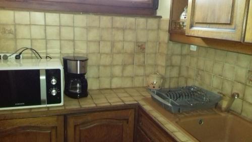 a kitchen with a counter top with a microwave at morel in Cluses