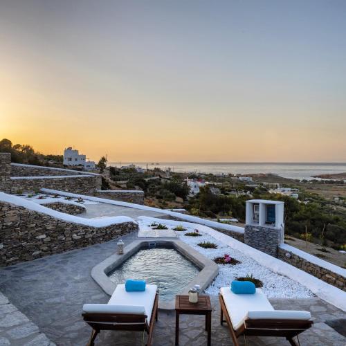 a hot tub on top of a building with the ocean at Peters Place - Paros Resort in Parasporos