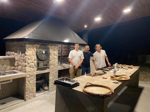 a group of people standing in front of a stone kitchen at Loto San Lorenzo I Studio in San Lorenzo