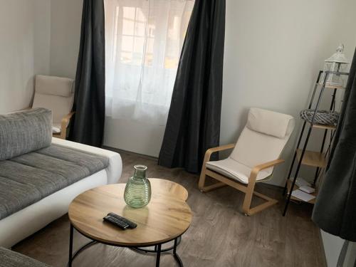 a living room with a couch and a table and a chair at hřensko 114 in Hřensko