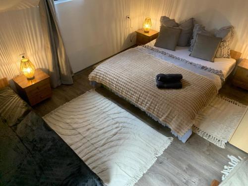 a bedroom with a bed with a black bag on it at hřensko 114 in Hřensko