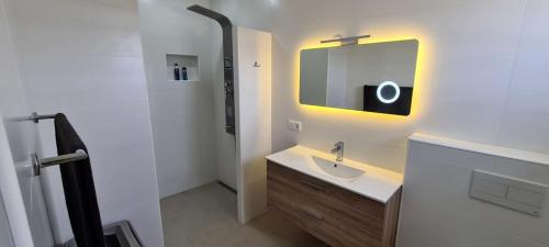La salle de bains est pourvue d'un lavabo et d'un miroir. dans l'établissement Bonaire Village Villa 23, à Kralendijk
